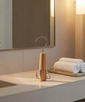 Heavy Duty Solid Wood Storage Hanger With Multiple Hooks on a bathroom counter with rolled towels.