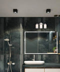 Three Light Brushed Nickel Bathroom Vanity Light Fixture With Frosted Seeded Glass in modern bathroom setting, wall-mounted above mirror