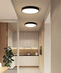 Round Flush Mount LED Ceiling Light 27W 15.7-Inch Black Modern Fixture illuminating a contemporary kitchen space.