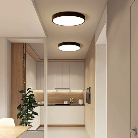 Round Flush Mount LED Ceiling Light 27W 15.7-Inch Black Modern Fixture illuminating a contemporary kitchen space.