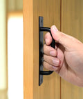 Hand pulling 5 Inch Black Barn Door Handle on cabinet