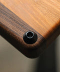 No Sweat Kitchen Upgrade Straight Up Heavy Duty Rubber Cutting Board Feet With Non Slip Protective Bumpers And Rust Proof Stainless Screws For Table Guarding Black Half Inch 8 Pack Set on wooden table corner.