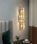 Gold Crystal LED Wall Light Sconce Dope Modern Elegant Wall Mount Lamp beside a bed in a modern bedroom