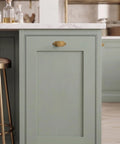 Premium Antique Brass Cabinet Knobs Paired With Elegant Oval Backplates 6 Pack on green cabinet drawer.