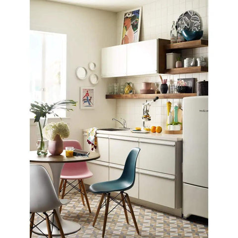 Modern kitchen with Refurbished Single Handle Faucet Kit LL on sink, surrounded by white cabinets, and colorful chairs.