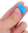 Close-up of blue bumper from 20Pc Rubber Drawer Slides Kit For Quiet Glide, held between fingers.