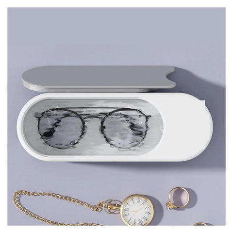 Portable Ultrasonic Cleaner For Jewelry Eyeglasses Retainers And Watches Pink Multifunctional Cleaning Gadget showing black glasses in clean water.