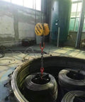 Rock Solid Single Leg Chain Sling - 2 Ton Heavy Duty Lifting Chain in use lifting wire coils in an industrial setting.