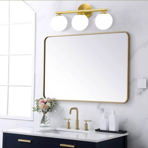 Rock A Stylish Mid Century Modern Vibe In Your Bathroom With These Three Light Gold Vanity Fixtures Complete With Frosted Milk Glass Globes And A Brushed Gold Frame That Is Dimmable Wall Mount Ready, installed above vanity with mirror.