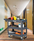 Heavy Duty Plastic Utility Cart With Wheels 550 Lb Capacity Three Tier Rolling Storage Organizer For Garage Warehouse And Industrial Use Built Tough Workhorse On Wheels with tools and supplies in hallway