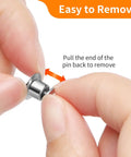 Holding a nickel plated copper clasp keeper, demonstrating easy removal for Hella Secure 30 Pack Locking Pin Backs For Sewing Needles.