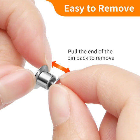 Holding a nickel plated copper clasp keeper, demonstrating easy removal for Hella Secure 30 Pack Locking Pin Backs For Sewing Needles.