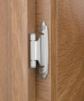 Chibery 3/8-inch inset cabinet hinge, brushed nickel, installed on a wood cabinet door; side view.