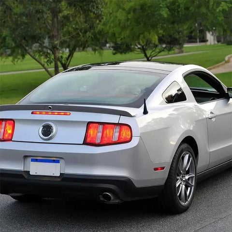 Rear view of a Ford Mustang 2010-2014 with a 3.8 Inch Aluminum Antenna Mast Replacement For Mustang 2010-2014, Transit 2013-2022, Lincoln MKZ 2013-2019, Ford Compatible Car Wash Proof Antenna Mast For Reliable Reception And DIY Friendly Install.
