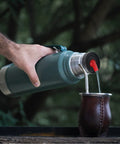 Person pouring liquid into mate cup using Thermal Flask Stopper Replacement For Yerba Mate Drinking Convert Your Thermos Into Yerba Mate Pico Mate Stopper With High Precision Flow Red On The Go For Camping And Travel.