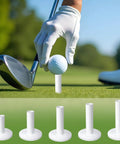 Golfer placing ball on unbreakable rubber golf tee, 5-piece mixed size white set, built to last for practice mats and simulators.