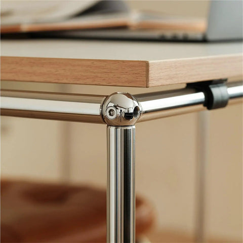 Close-up of Rock Solid PC Desk with smooth gliding casters, showing sturdy chrome frame and sleek wooden tabletop.