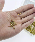 Hand holding gold finish self tapping screws bulk pack 1200Pcs countersunk M2 M2.5 M3 for wood plastic and soft metal DIY projects