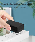 Go-To 5V 2A Power Adapter With 11 Interchangeable DC Plug Tips, black wall adapter plugged into power strip