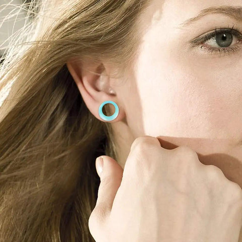 Close-up of a woman wearing a blue Colorful Silicone Ear Gauges Plugs Set with Double Flared Tunnels.