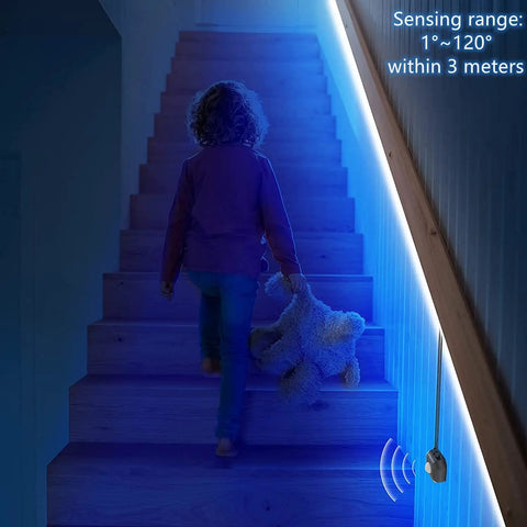 Child walking upstairs illuminated by motion activated under bed lights with 2x9.84 ft RGB LED strips sensor auto on in the dark.