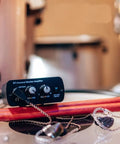 S1 Personal In-Ear Monitor Headphone Amplifier for Drummers on a drum kit with drumsticks, compact IEM system for stage use.