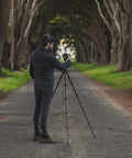 Man using Carbon Fiber Travel Tripod With Pro Level Stability, Fast Setup And Takedown, Ergonomic Ball Head outdoors.
