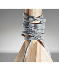 Close-up of Eden Table Lamp With Natural Ash Wood Tripod Base, featuring a black white fabric cord wrapped around the tripod