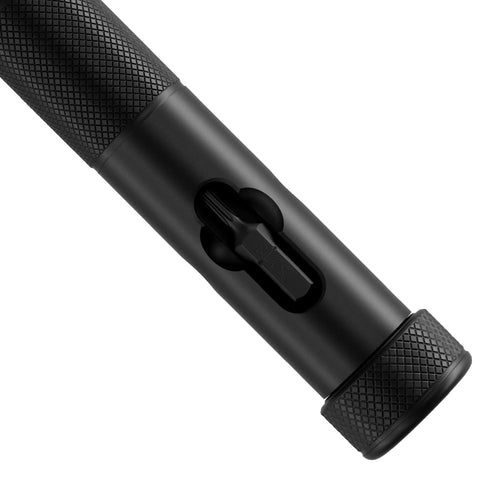 Close-up of Bullet V2 Multi Use Bit Driver for EDC with S2 Steel Torx Bits T6 T8 and T10, black textured aluminum grip, showing bit insertion.