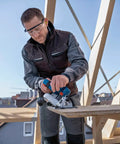 Badass 18V Cordless Brushless Circular Saw With Slick Six Point Five Inch Blade in use on lumber at a construction site.