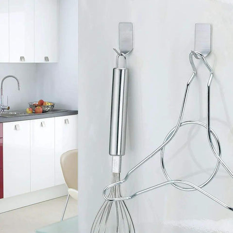 Ultra Strong Stainless Steel Adhesive Hooks For Wall Mounting Holds Hats Caps Keys And Kitchen Utensils Up To 5 Lb Waterproof Wall Rack Hooks 20 Pack For Kitchen Bathroom Cabinets shown holding kitchen utensils in a modern kitchen setting.