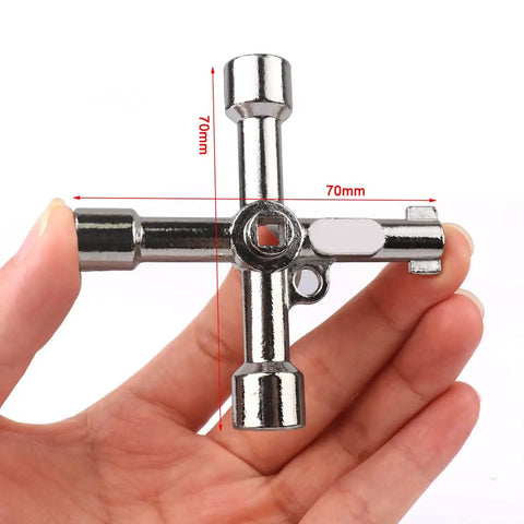 Hand holding one key from the Ten Piece Electrical Cabinet Key Set With Rustproof Zinc Alloy Four Way Utility Keys Triangle Square And Panel Cross For Faucet Gas Meter Valve Spigots And Electrical Cabinet Access
