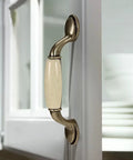 Eight Piece Ceramic Drawer Handles Set In Chinese Style With Vintage Antique Design for cabinets, beige ceramic knob installed on door.