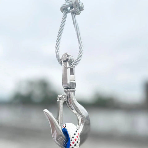 Rock Solid 316 Stainless Steel Clevis Slip Hook With Swivel Lift And Safety Latch 5/16 Inch 1430 Lbs Rigging Accessory hanging from cable.