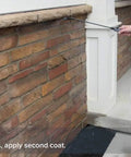 Person applying All Purpose Outdoor Masonry Sealer For Brick Stone And Concrete Clear Penetrating Waterproof Sealant That Creates A Deep Weatherproof Barrier And Keeps Water Out On Exterior Surfaces 1 Gallon to brick wall using a spray applicator.