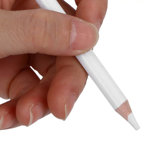 Hand holding a white charcoal pencil from the White Charcoal Pencils Carbon Drawing Set 9 Pieces for Sketching and Illustration Expressive Lines Deep Bold Tones Wood and Graphite Sketching Accessories for Art Students.