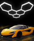 Hexagon Garage Lights LED 25 Pack 220W 26400LM 6500K Daylight White Ceiling Lighting illuminating a yellow sports car