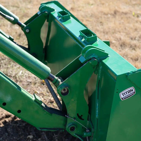 Close-up of 5 Foot Dirt Bucket Attachment For Tractors That Fits John Deere Hook And Pin Tractors showing reinforced gussets