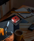 Battery Converter For Milwaukee 18V Batteries With USB Charger, DC Port And 3W LED Work Light on a workshop table.