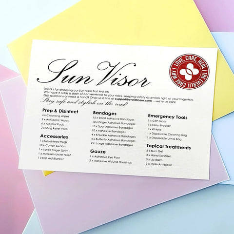 Sun Visor car first aid kit contents card; white sheet with black text and red circular logo.