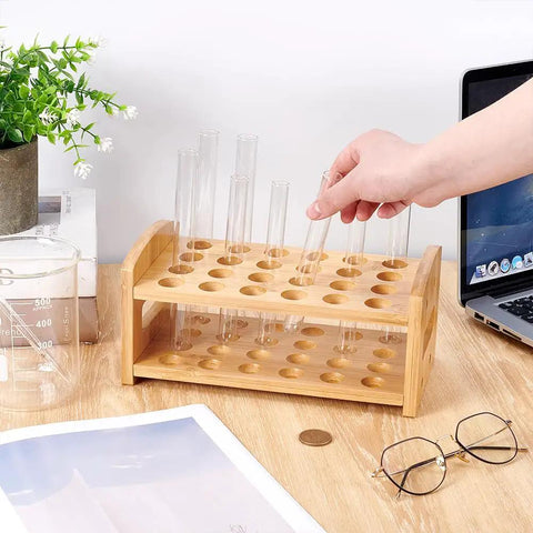 Hand placing tube in Wooden 24-Hole Bamboo Test Tube Rack Rectangle Lab Organizer For 20mm Diameter Tubes on desk.