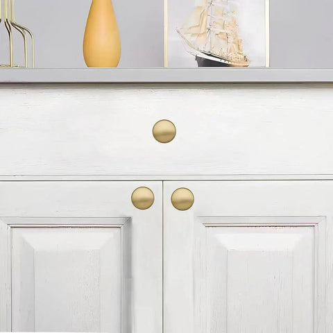 20 Pack Brushed Brass Cabinet Knobs Heavy Duty Zinc Alloy Bifold Closet Door Hardware Built Tough for Kitchen Cabinets and Bathrooms Fingerprint Resistant Champagne Bronze Finish on white cabinet
