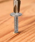 Close-up of Heavy-Duty 410 Stainless Self-Tapping Screws Set With Flat Head Phillips Self-Drilling for Wood in action