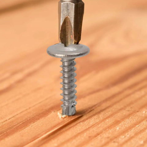 Close-up of Heavy-Duty 410 Stainless Self-Tapping Screws Set With Flat Head Phillips Self-Drilling for Wood in action