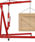Heavy Duty Garage Workhorse: 2 Ton Hydraulic Engine Hoist With Adjustable 0.5 To 2T Range lifting a wooden crate on a workshop floor.