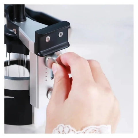 Close-up of a hand adjusting the knob on a Professional Espresso Distribution Wand Smooth Rotation Coffee Stirrer.