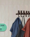 Hella Tough Cast Iron Wall Hook Rack With Seven Cute Cat Designs For Coats Keys And Hats, Vintage Rustic Brown decorative rack with blue and orange coats.