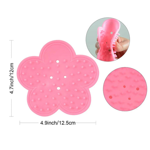 Pink silicone flower-shaped scrubber with dimensions shown, featuring close-up of flexible material and textured surface.