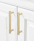 10 Pack 5 Inch Brushed Brass Knurled Cabinet Handles installed on white kitchen cabinets with gold pulls and door hardware
