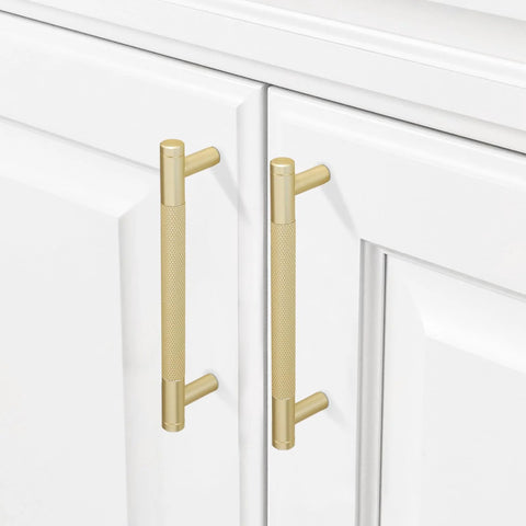 10 Pack 5 Inch Brushed Brass Knurled Cabinet Handles installed on white kitchen cabinets with gold pulls and door hardware